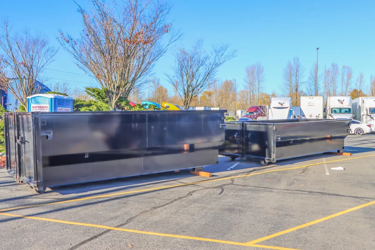 Professional dumpster rental service with roll-off container on residential driveway in Chowchilla